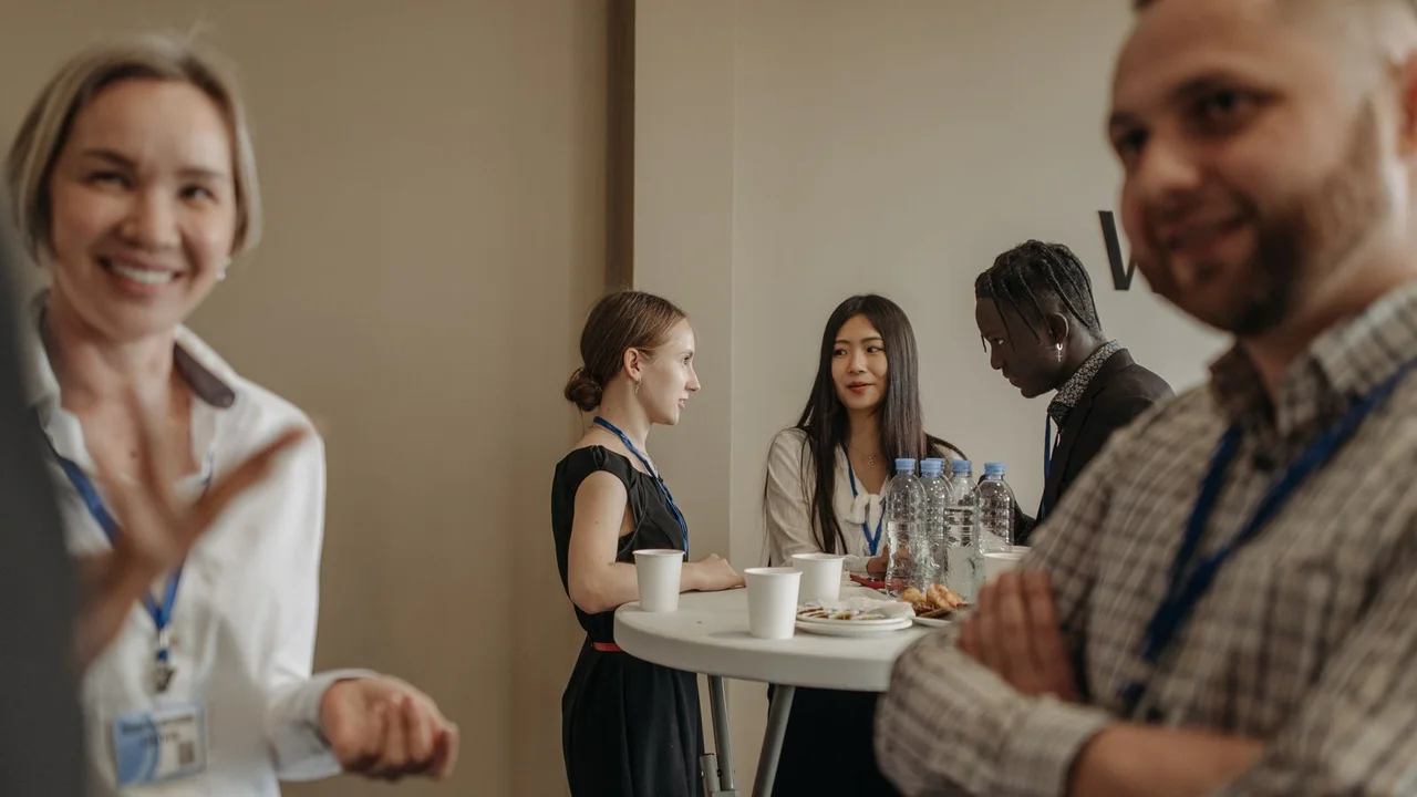 Small groups of adults beginning conversations during a professional networking event