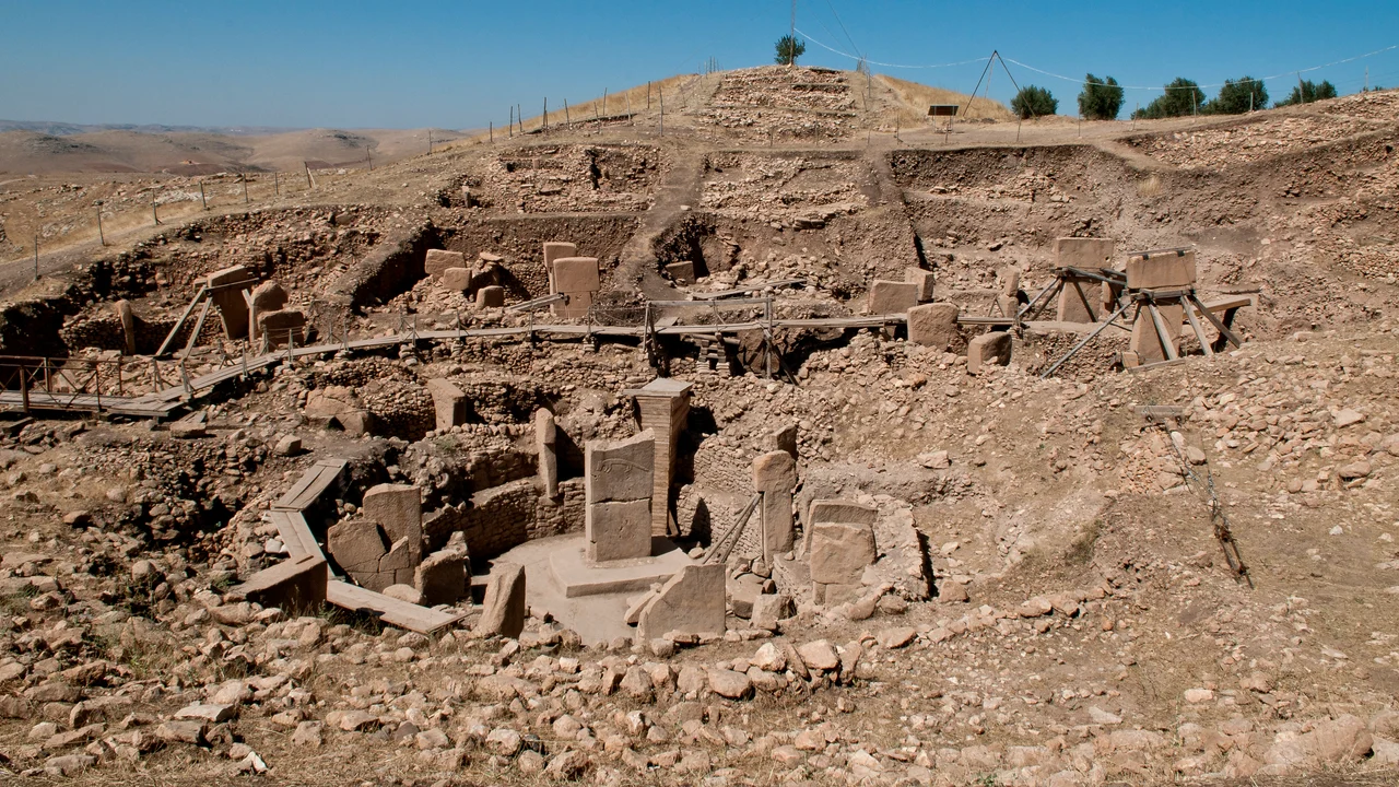 Excavated T-shaped limestone pillars standing inside a stone enclosure at Göbekli Tepe