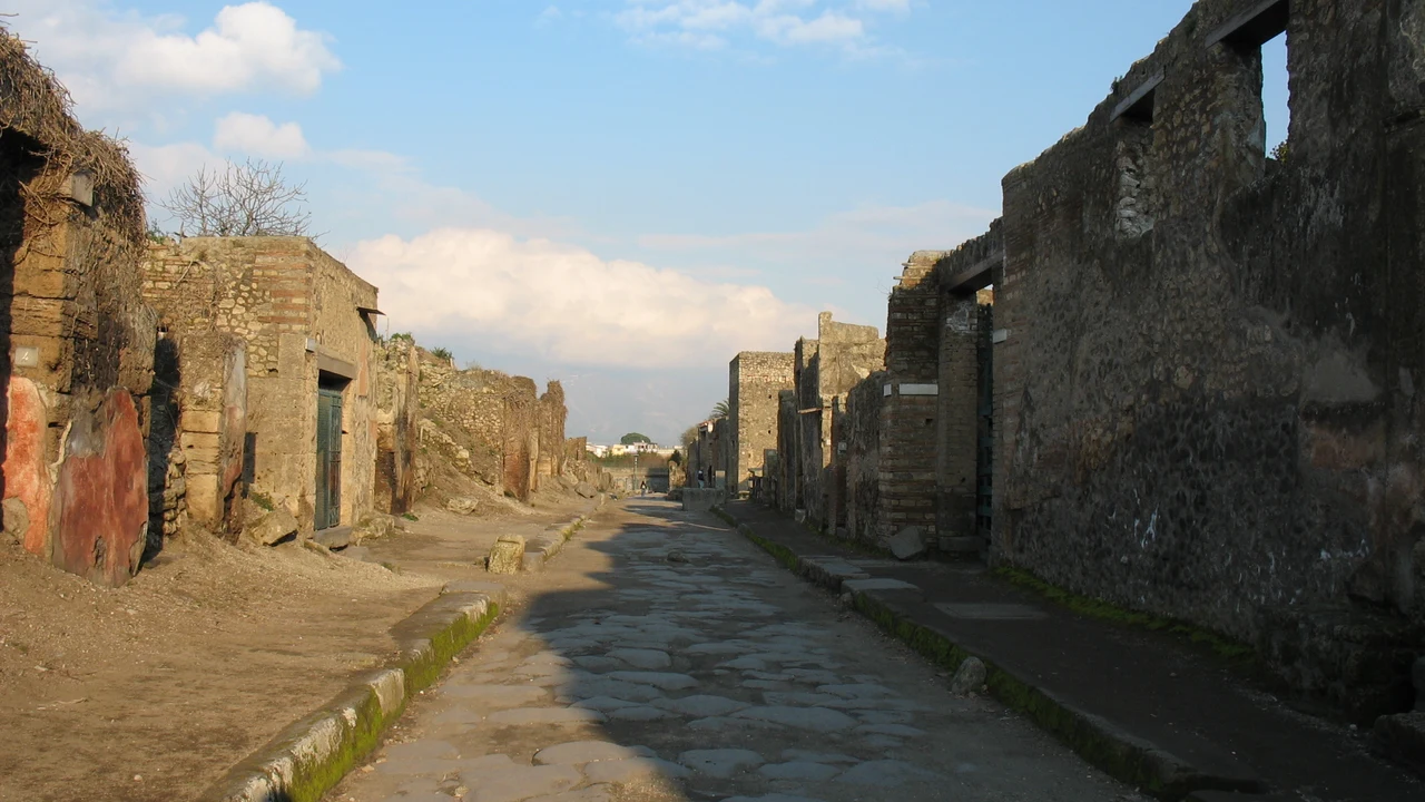 The paved Via dell'Abbondanza running between preserved house and shop fronts at Pompeii