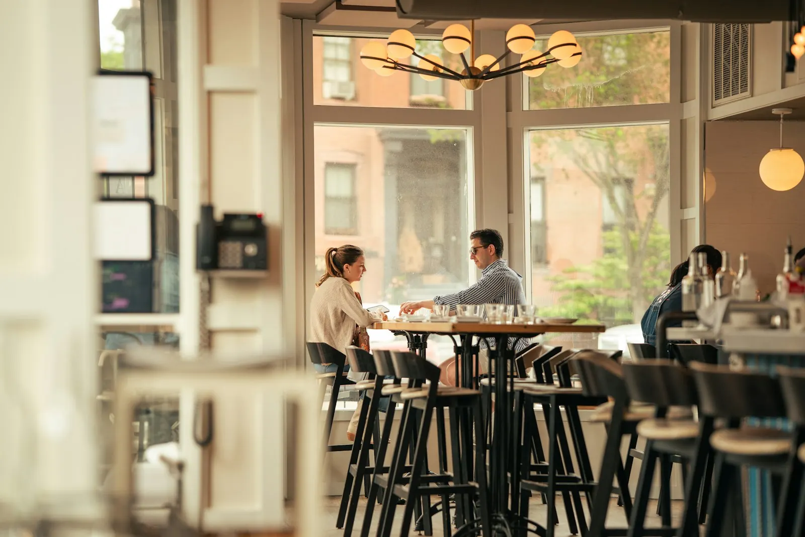 Two people talking together at a cafe table