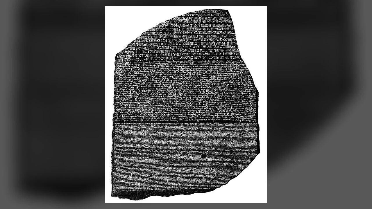 A frontal view of the broken Rosetta Stone showing its surviving hieroglyphic, Demotic and Greek inscriptions