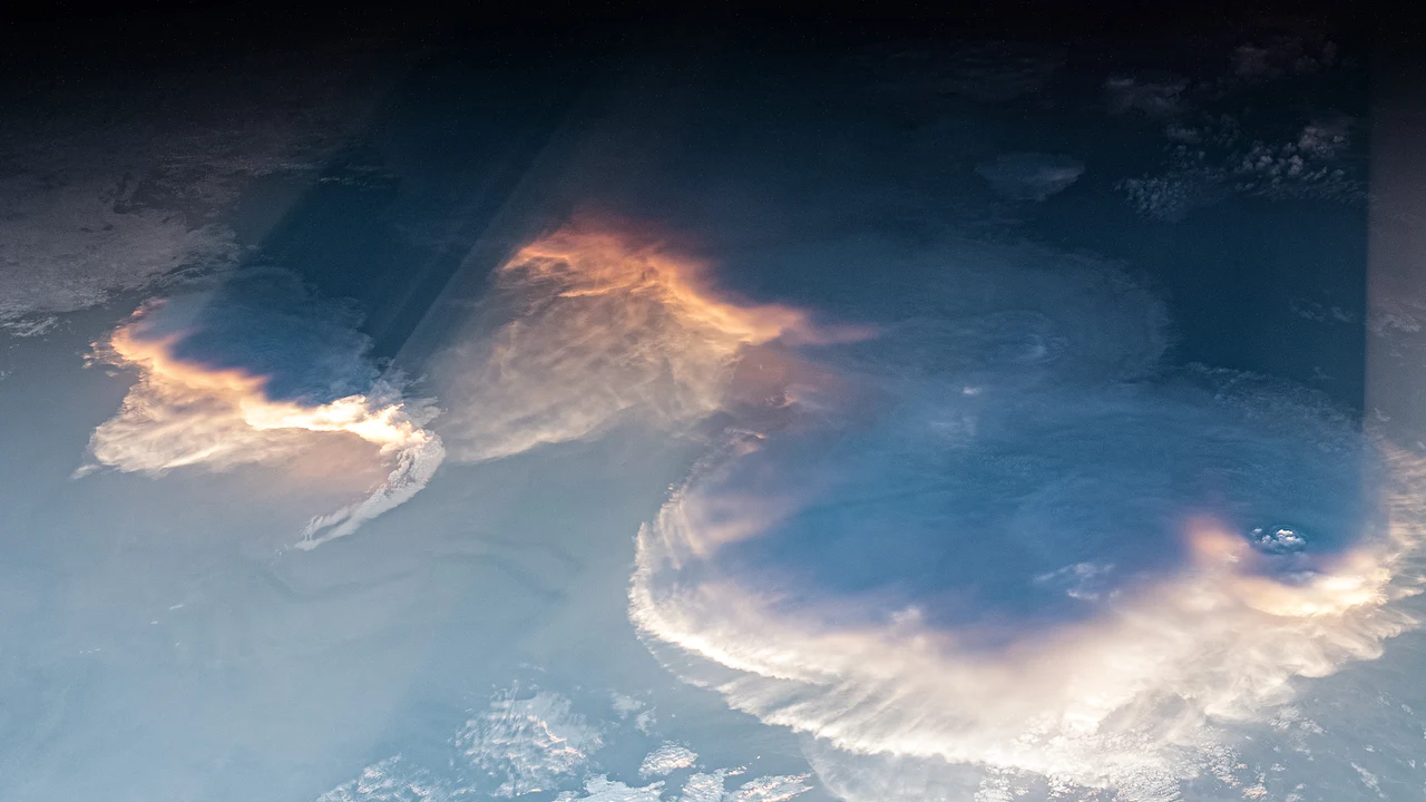 Low sunset light, bright anvil clouds and long crepuscular shadows photographed from the International Space Station