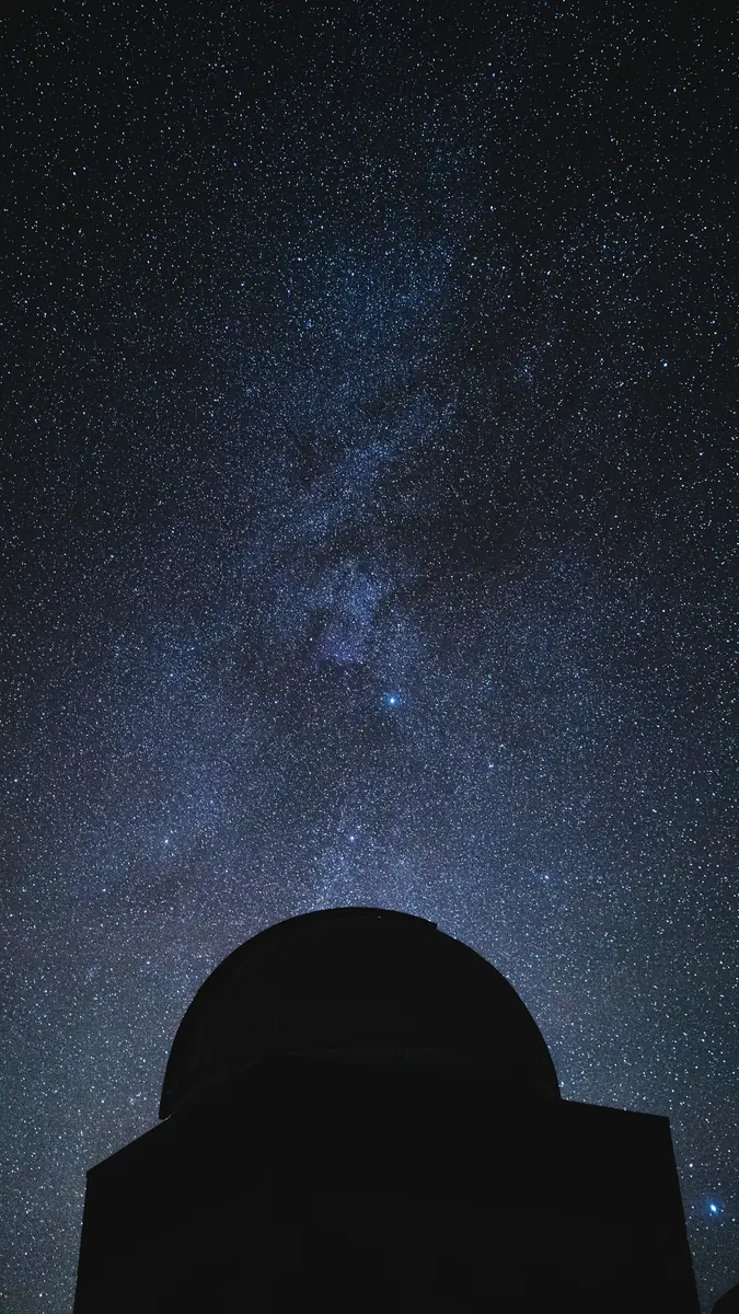 A telescope beneath a dense field of stars