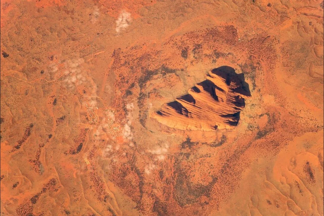 Uluṟu and the surrounding Central Australian landscape photographed from orbit