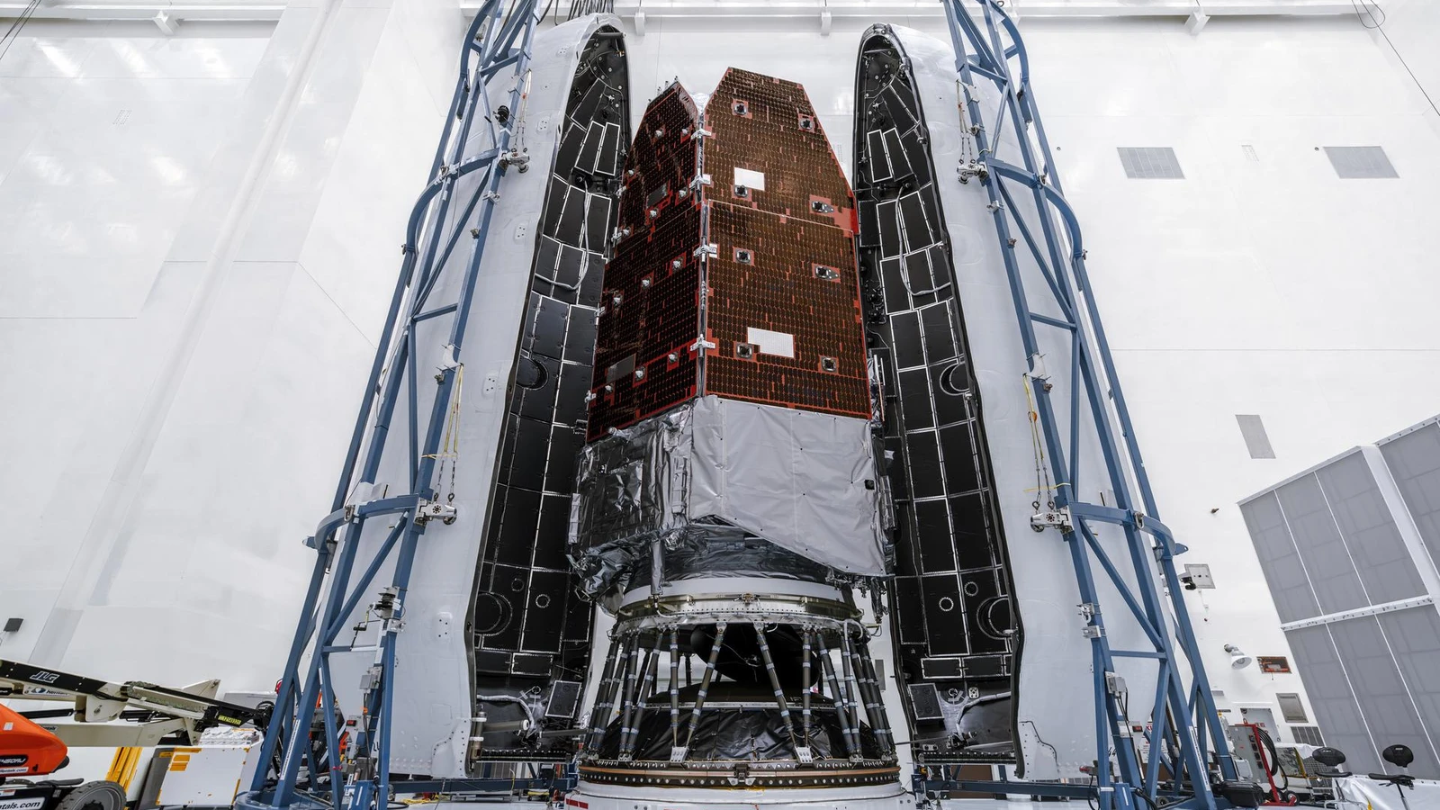 NASA photograph of the Roman Space Telescope hardware standing inside an opened Falcon Heavy payload fairing in a cleanroom