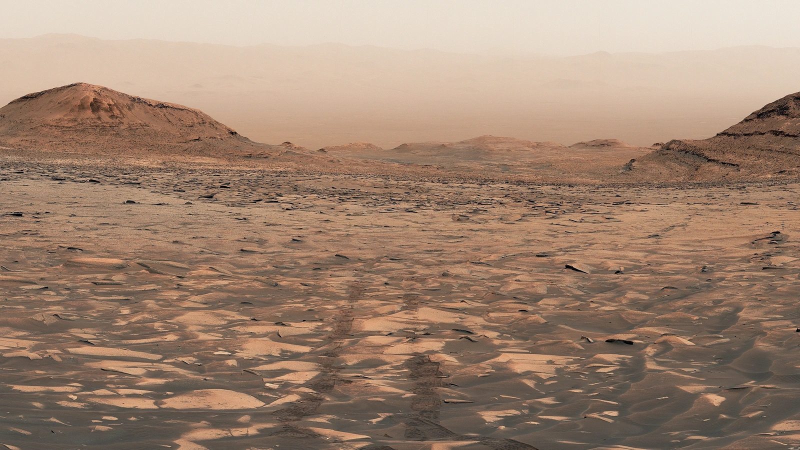 Curiosity rover tracks receding through a dusty rocky Mars landscape in NASA's Figure A crop from Valle Grande