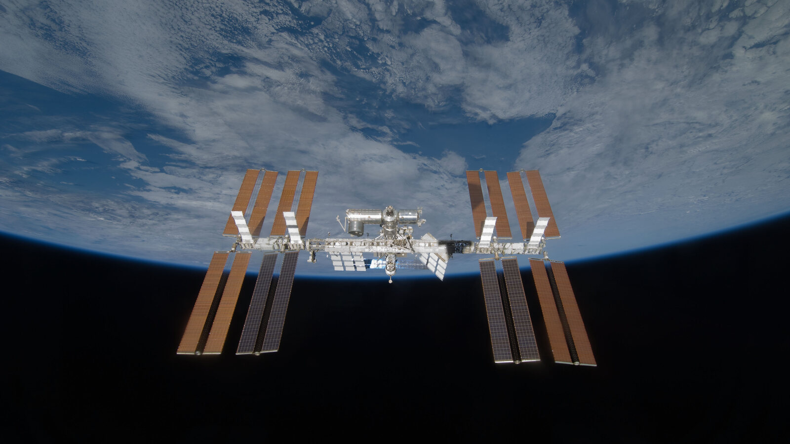 The International Space Station seen above Earth's curved blue horizon from Space Shuttle Discovery after undocking in March 2009