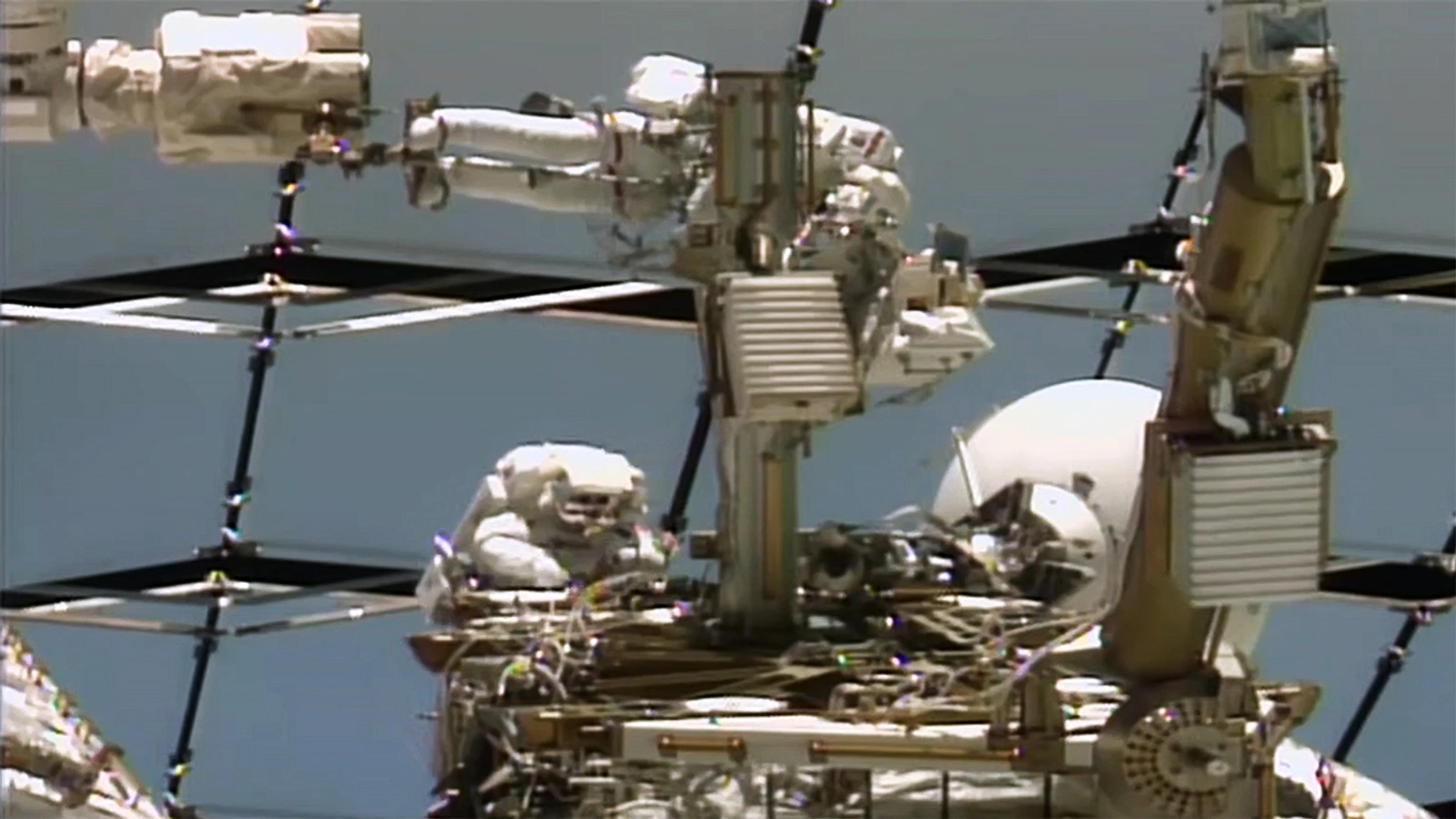 NASA view of Anil Menon and Sophie Adenot working on a Space-to-Ground antenna outside the International Space Station during the August 18, 2026 spacewalk