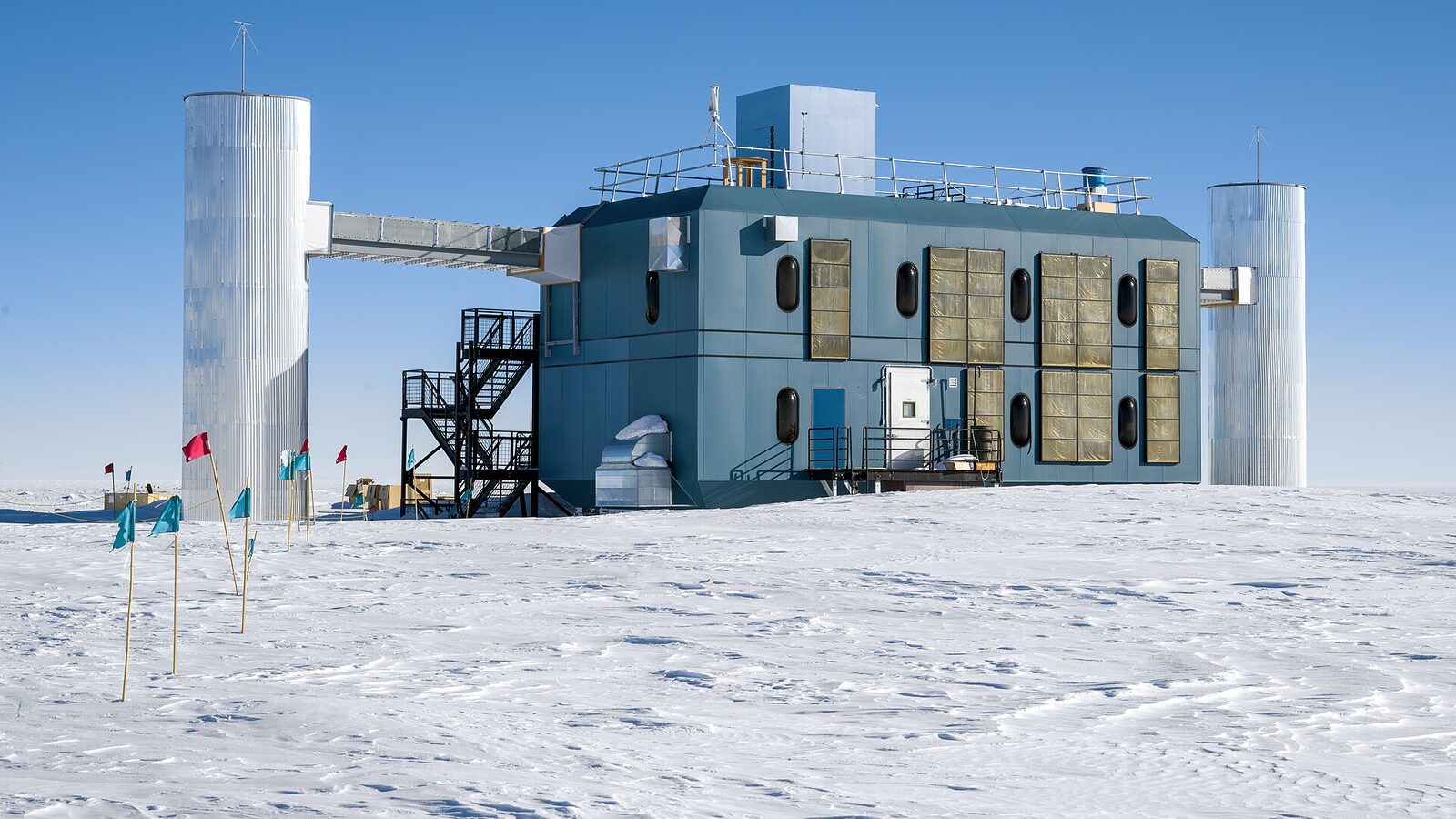 The IceCube Laboratory building standing on the bright Antarctic ice at the Amundsen-Scott South Pole Station