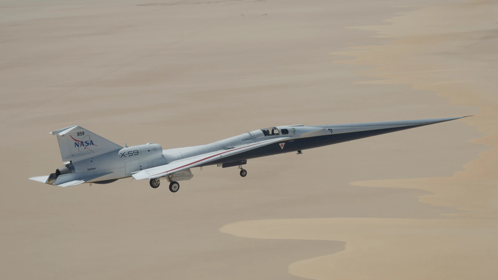 NASA's X-59 quiet supersonic research aircraft flying over Rogers Dry Lake near NASA Armstrong Flight Research Center