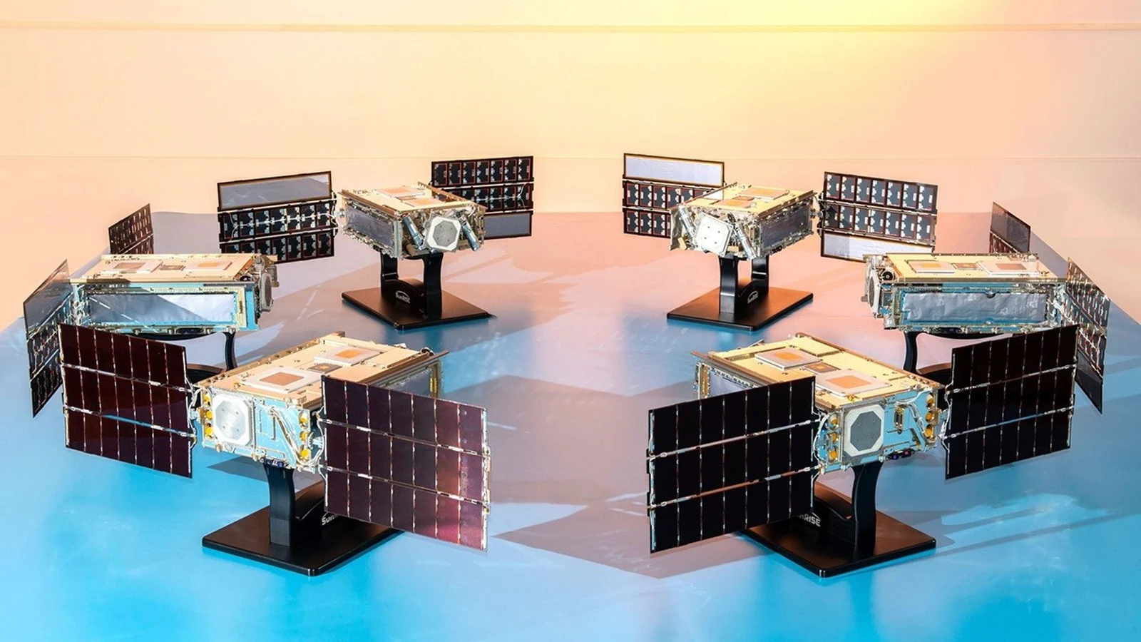 NASA Photojournal photograph of six completed SunRISE SmallSats arranged together with their solar panels at Space Dynamics Laboratory