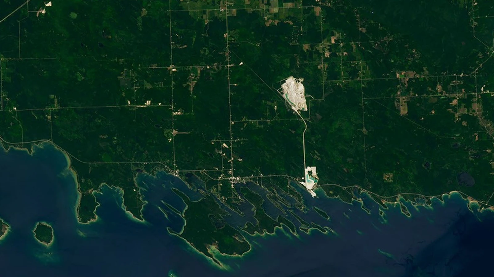 NASA Landsat 9 view of Michigan's Les Cheneaux Islands, with elongated islands and bright shallow water along Lake Huron