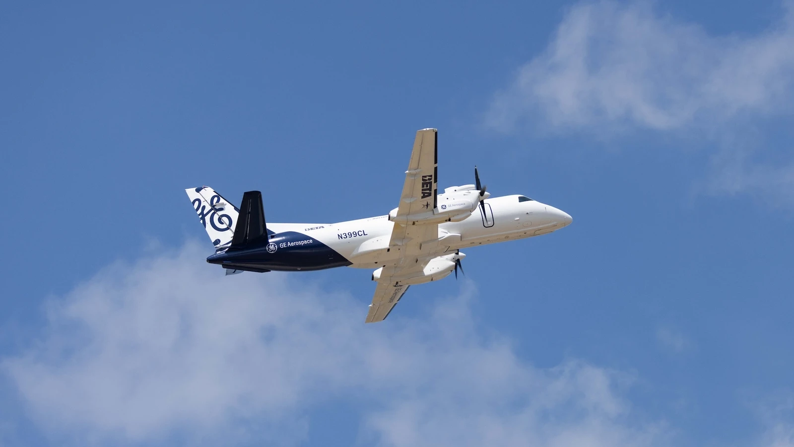 Modified Saab 340B aircraft with a GE Aerospace hybrid-electric engine flying against a blue sky